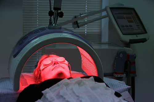 PDT treatment showing patient under red activating light
