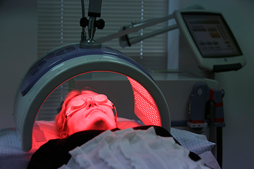 PDT treatment showing patient under red activating light
